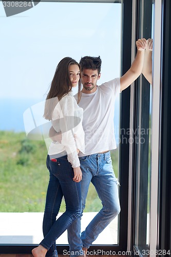 Image of relaxed young couple at home staircase