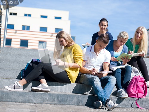 Image of students outside sitting on steps