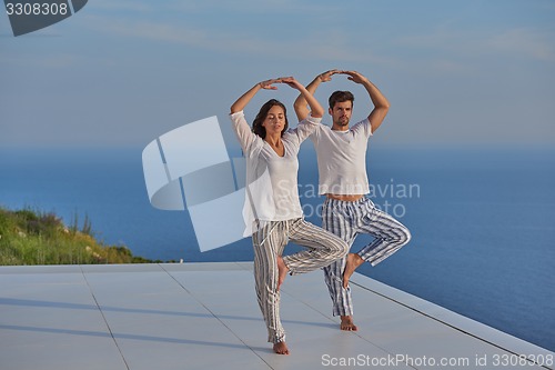 Image of young couple practicing yoga