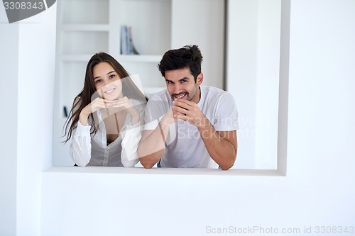 Image of relaxed young couple at home staircase