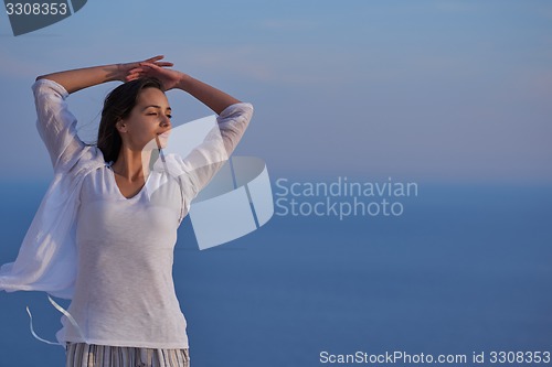 Image of young woman enjoy sunset