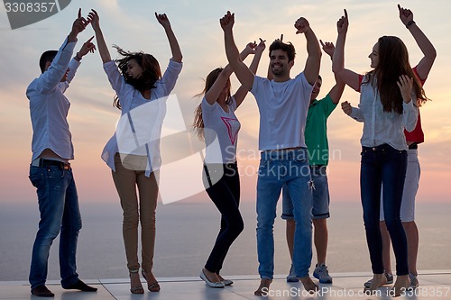 Image of party people  on sunset