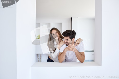 Image of relaxed young couple at home staircase