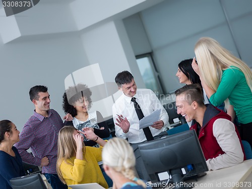 Image of students with teacher  in computer lab classrom