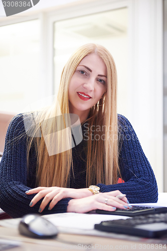 Image of business woman working on computer at office