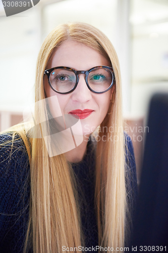 Image of business woman working on computer at office