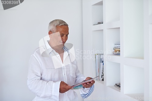 Image of Portrait of senior man relaxing in sofa