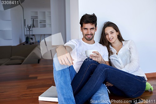 Image of relaxed young couple at home staircase