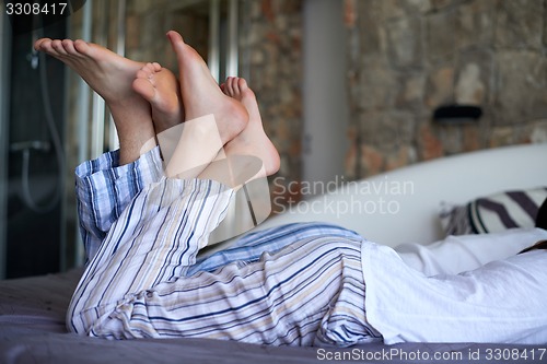 Image of couple relax and have fun in bed