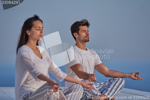 Image of young couple practicing yoga