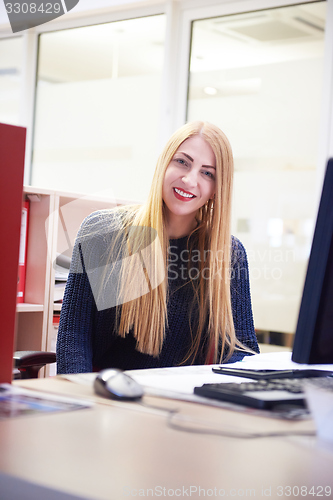 Image of business woman working on computer at office