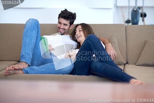 Image of couple at modern home using tablet computer