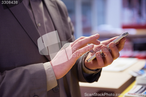 Image of business man working on phone at office