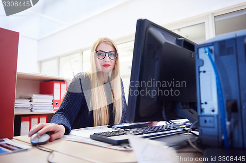 Image of business woman working on computer at office