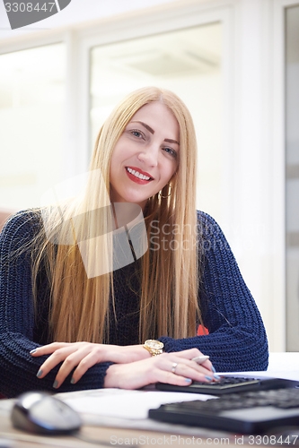 Image of business woman working on computer at office