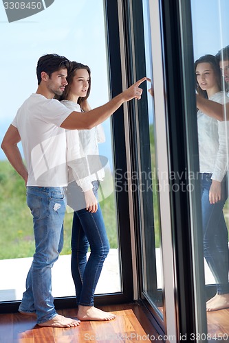 Image of relaxed young couple at home staircase