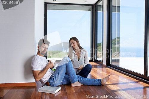 Image of relaxed young couple at home staircase