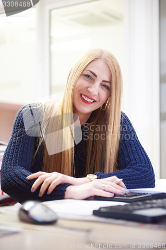 Image of business woman working on computer at office