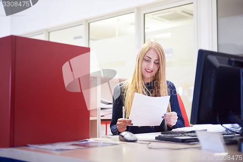 Image of business woman working on computer at office