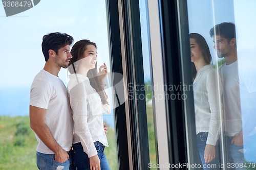 Image of relaxed young couple at home staircase
