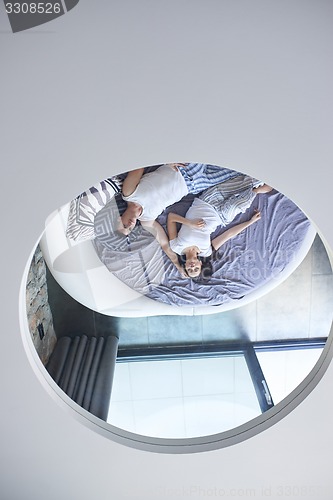 Image of couple relax and have fun in bed