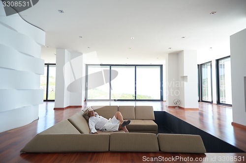 Image of Portrait of senior man relaxing in sofa