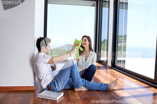 Image of relaxed young couple at home staircase