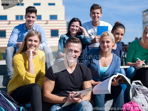 Image of students outside sitting on steps