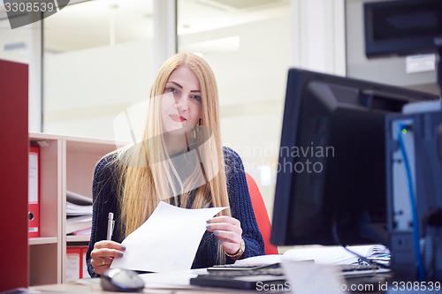 Image of business woman working on computer at office