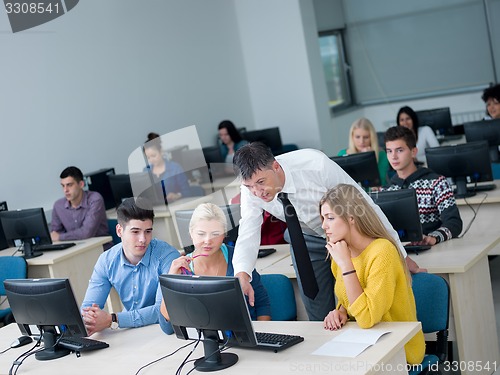 Image of students with teacher  in computer lab classrom