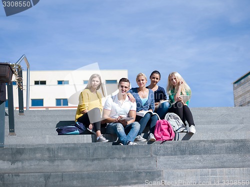 Image of students outside sitting on steps