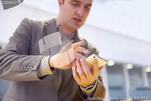 Image of business man working on phone at office