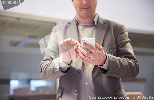 Image of business man working on phone at office