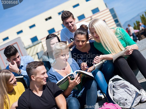 Image of students outside sitting on steps