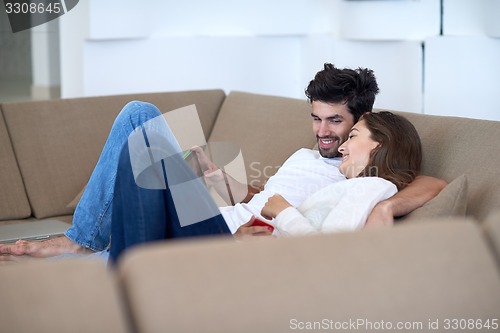 Image of couple at modern home using tablet computer