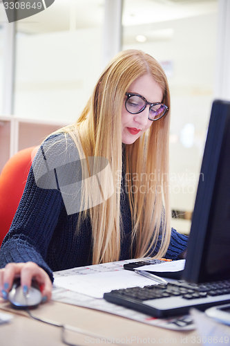 Image of business woman working on computer at office
