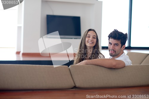 Image of relaxed young couple at home staircase