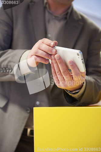 Image of business man working on phone at office