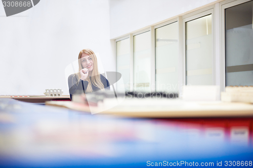 Image of business woman working on computer at office
