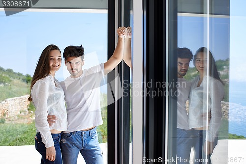 Image of relaxed young couple at home staircase