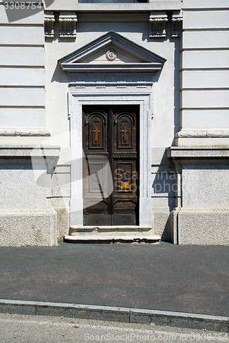 Image of old castronno   in  italy   the old  wall  and church door  