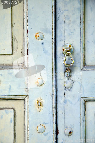 Image of abstract cross   brass brown knocker in   venegono  varese italy