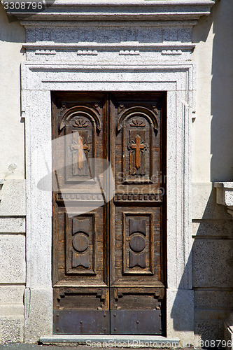Image of old castronno abstract in  italy   and church door  