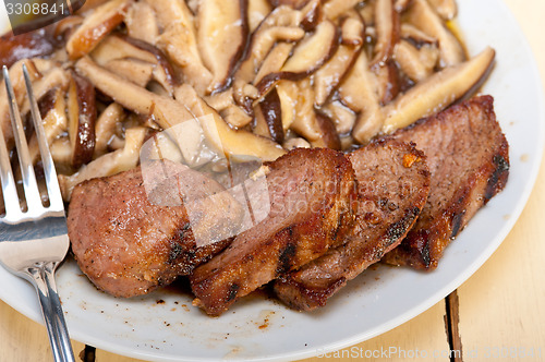 Image of venison deer game filet and wild mushrooms