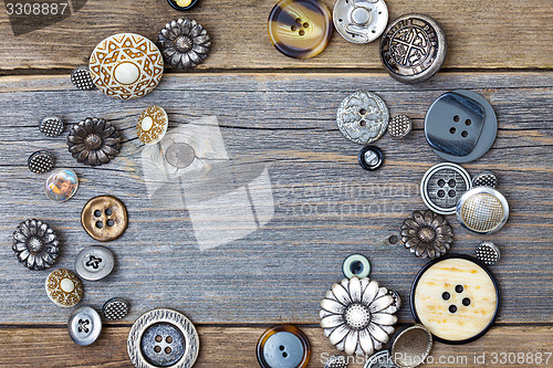 Image of several old buttons on the vintage table surface