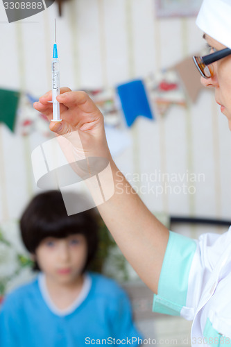 Image of Doctor pediatrician with a syringe