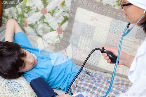 Image of children\'s doctor measures the blood pressure of boy