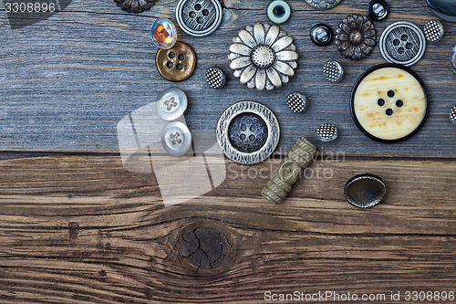 Image of Vintage buttons on the old wooden surface
