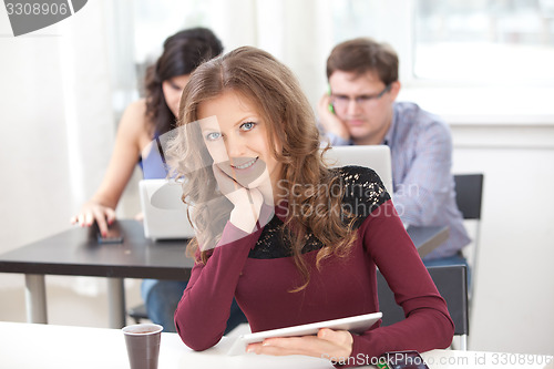 Image of smiling young girl with tablet