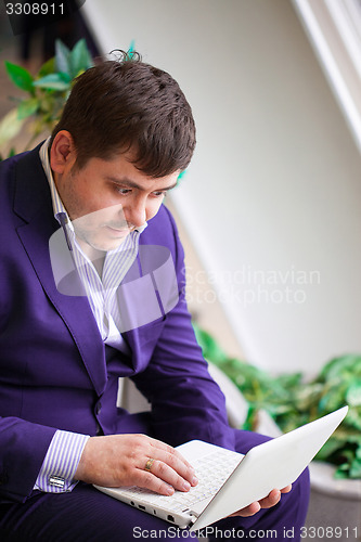 Image of businessman watching stock quotes